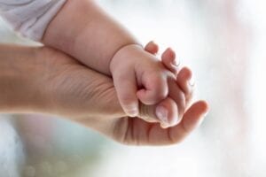 A close up of two hands holding each other